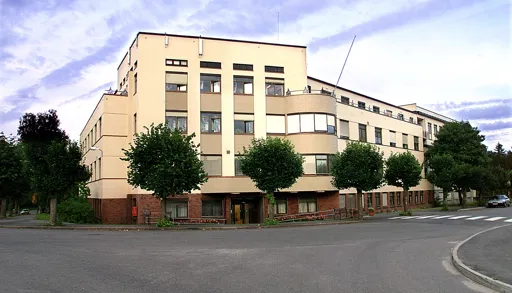 A large building with trees in front of it